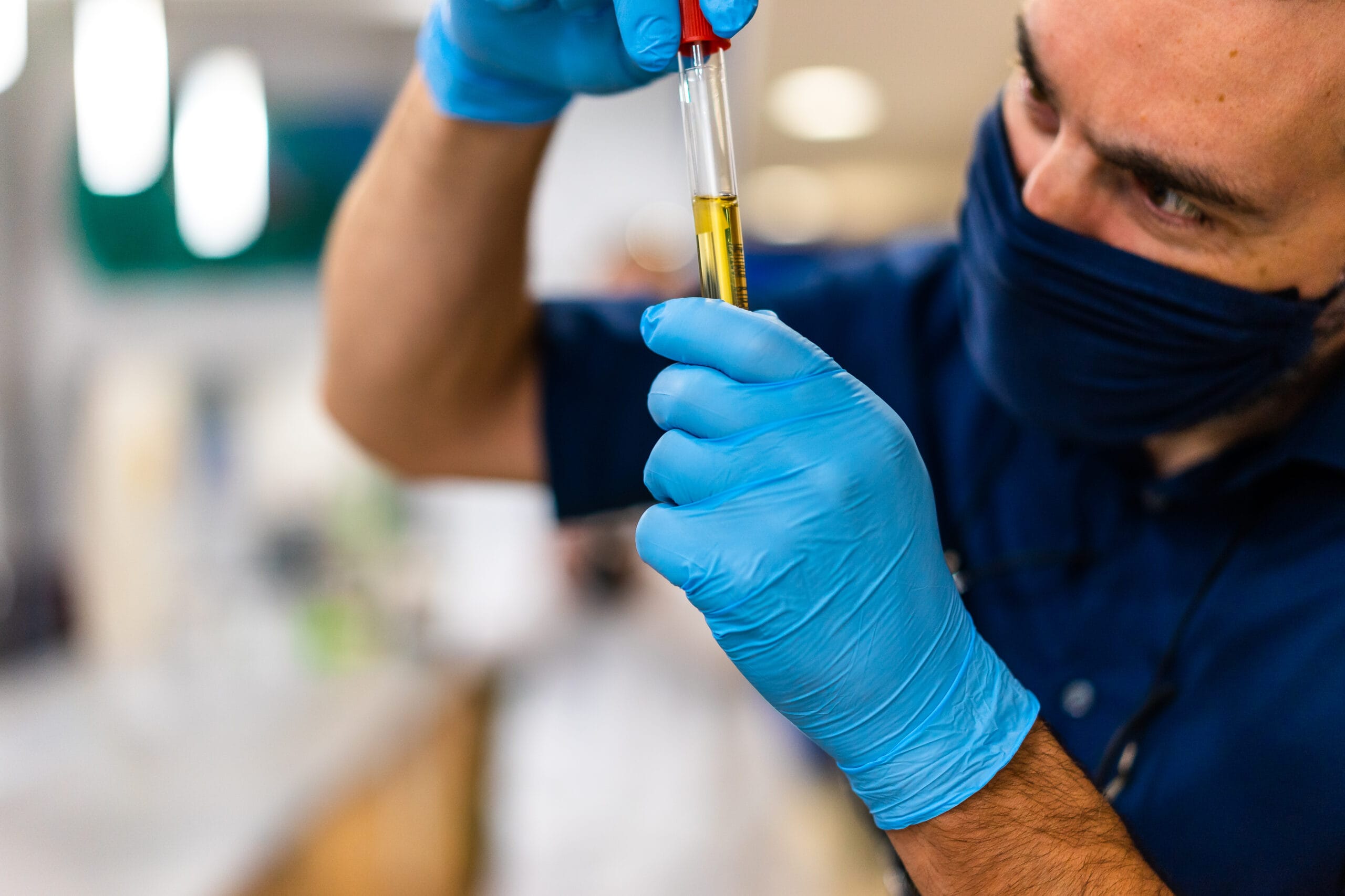 Employee pipetting sample into vial